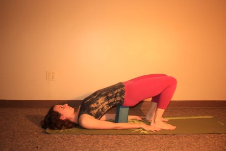 Supported Bridge: Use your block under your sacrum for a more restorative version of the posture. Remember, the higher you place the block, the deeper you will get into your backbend. 